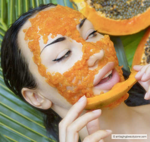 Woman using a papaya enzyme face mask.