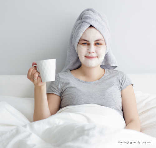 Woman wearing an overnight face mask in bed.