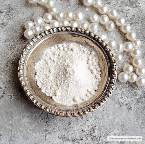 Crushed up pearls in powder form in a silver bowl.