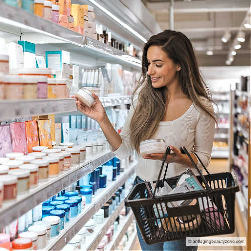 A woman shopping as she examines jars of sugar face scrubs designed for sensitive skin.