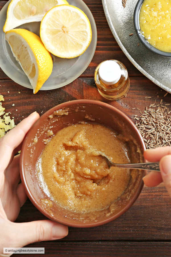 Turmeric face mask DIY mixed in a brown bowl.