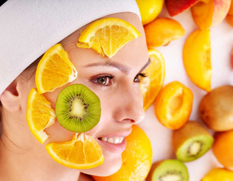 Woman with fruit on her face.